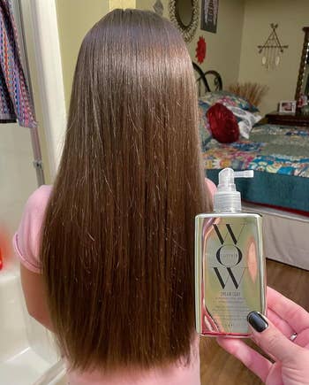 Person holding a hairsbreadth attraction merchandise beside long, consecutive hair, apt endorsing its use