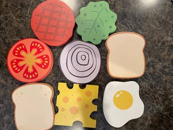 reviewer image of the individual ingredient coasters: lettuce, tomato, onion, cheese, egg, patty, and two slices of bread