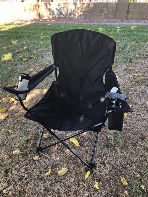 reviewer photo of the black camper chair outside
