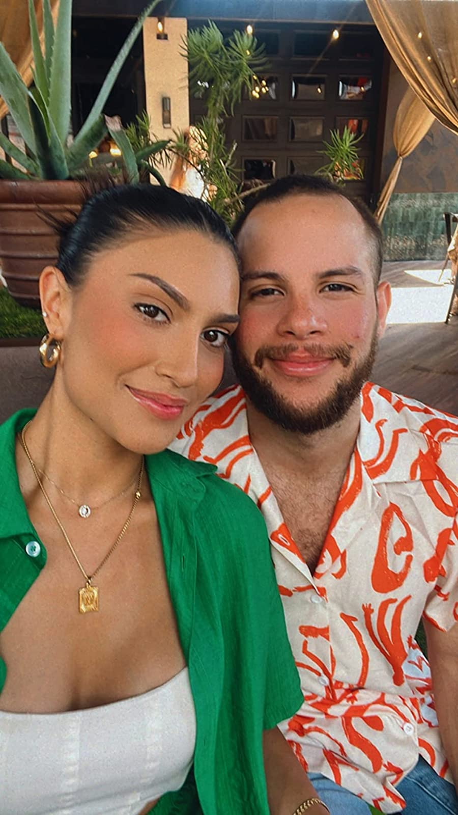 a reviewer wearing the M necklace