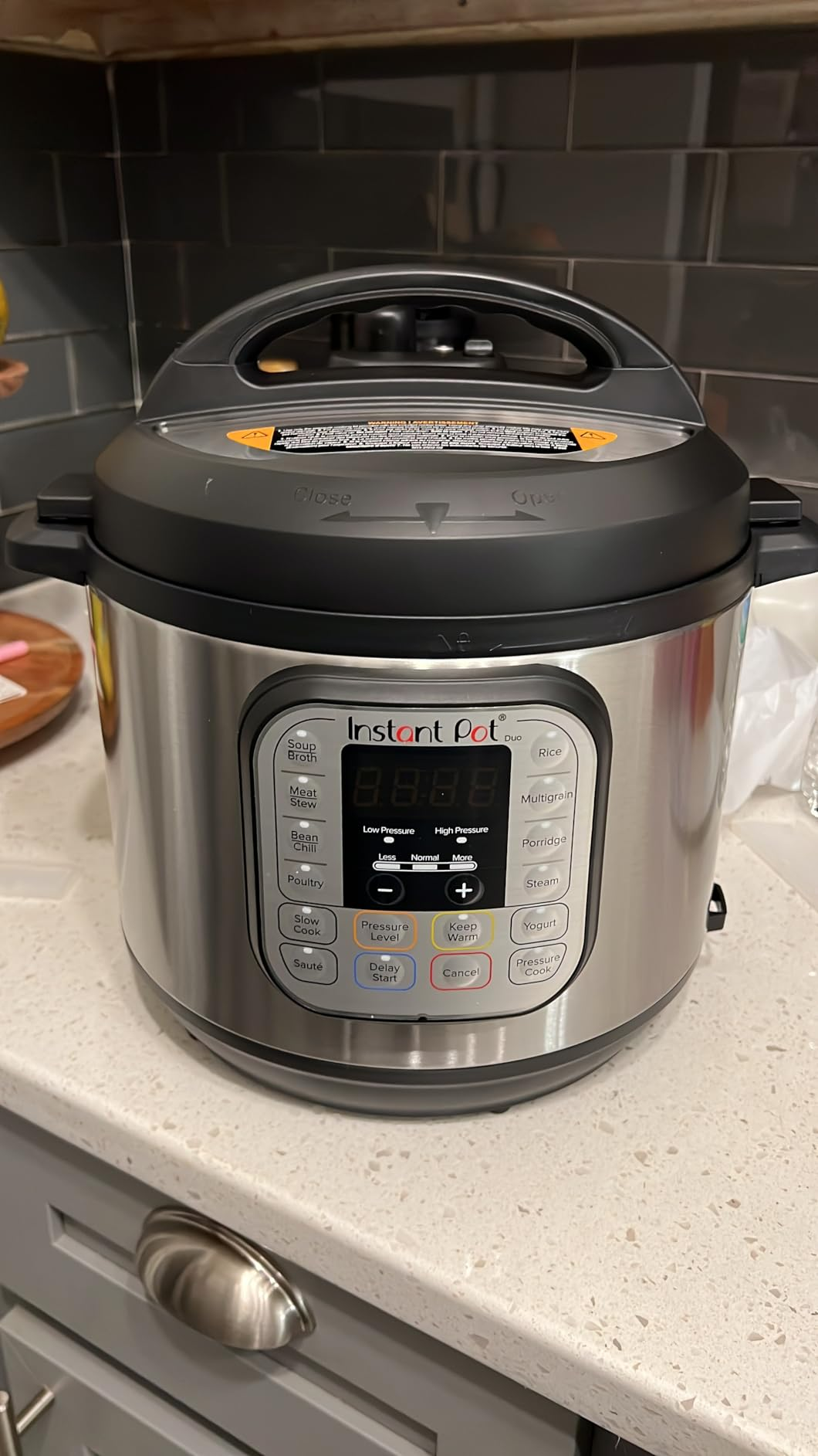 Instant Pot unit   cooker connected  a room  antagonistic  with power  sheet  showing settings