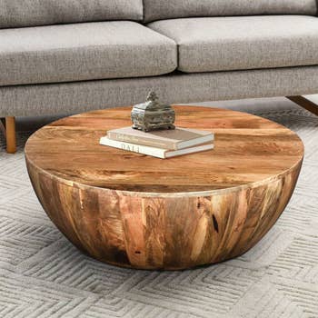 Image of the brown wood coffee table with books on it