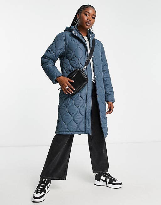 model posing in the long blue coat