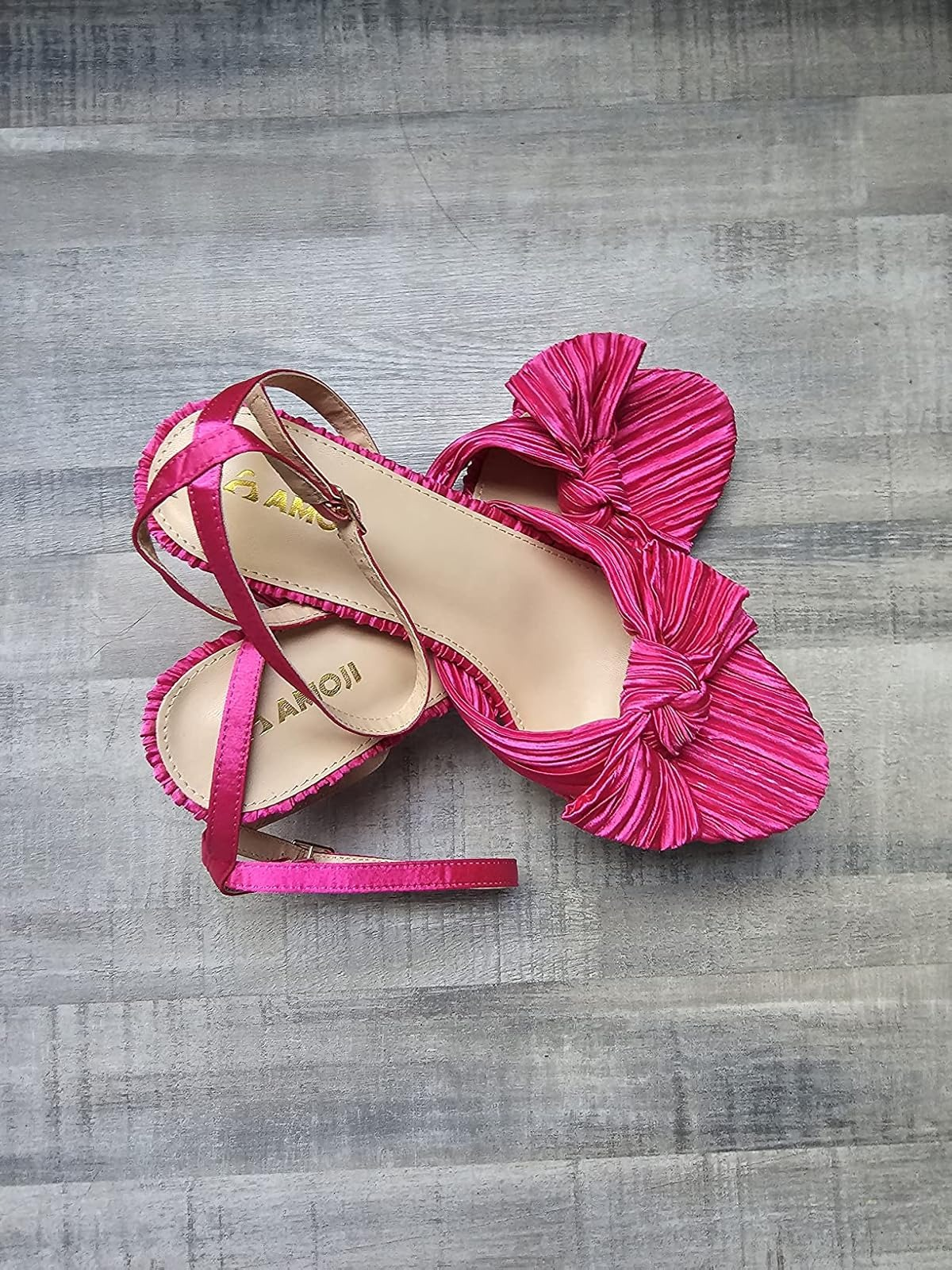 Pink sandals with bow accents and ankle straps