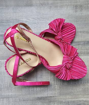 Pink sandals with bow accents and ankle straps