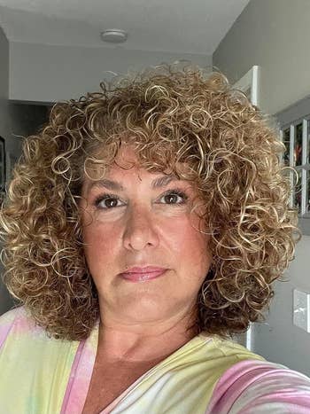 a reviewer with shiny, loose curls