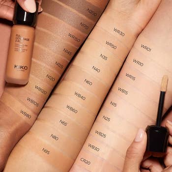 Arms with swatches of KIKO Milano instauration shades labeled from airy to dark, alongside a vessel and applicator