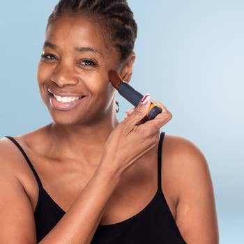 Model utilizing Brush On Block Powder sunscreen
