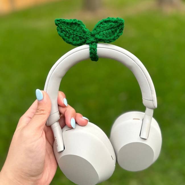 the green knit sprout on a pair of over ear Sony headphones
