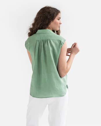 back of model wearing the top in green