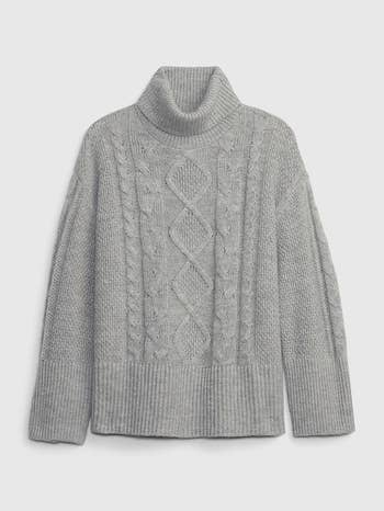 a gray turtleneck split hem cableknit sweater