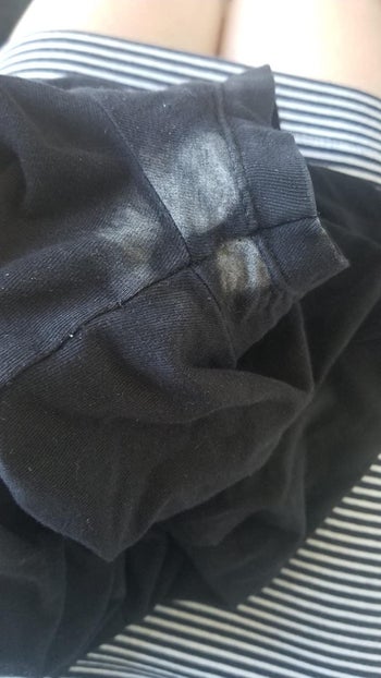 reviewer before image of a black shirt with white deodorant stains