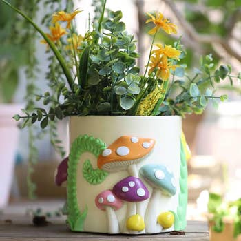 a planter with a colorful mushroom design