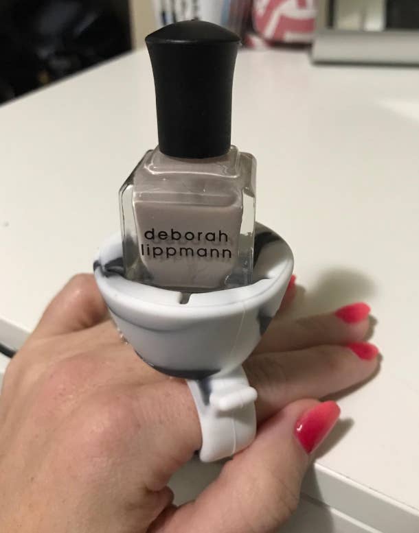 reviewer wearing polish ring with grey nail polish bottle in it