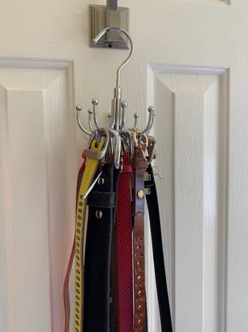 another reviewer's belts on the hanger, which  is hanging from a hook on a door