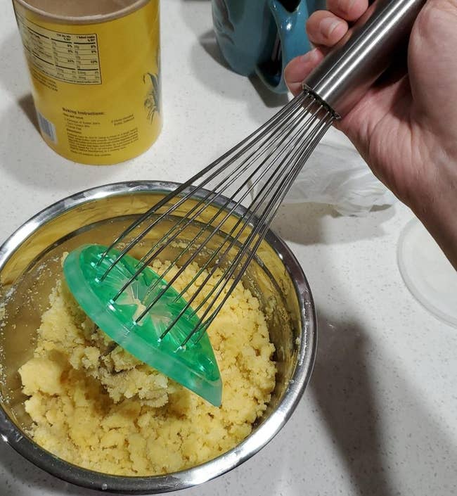 reviewer sliding cookie dough off of a whisk
