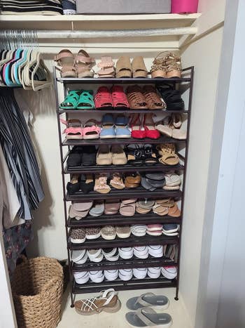 A variety of shoes organized on a rack with multiple shelves in a closet, illustrating storage options for footwear