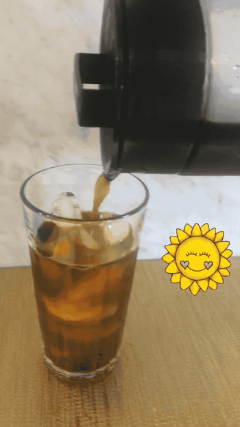gif of person pouring cold brew into a glass with ice 