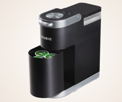 The black Keurig with the storage compartment slightly out showing the pods inside