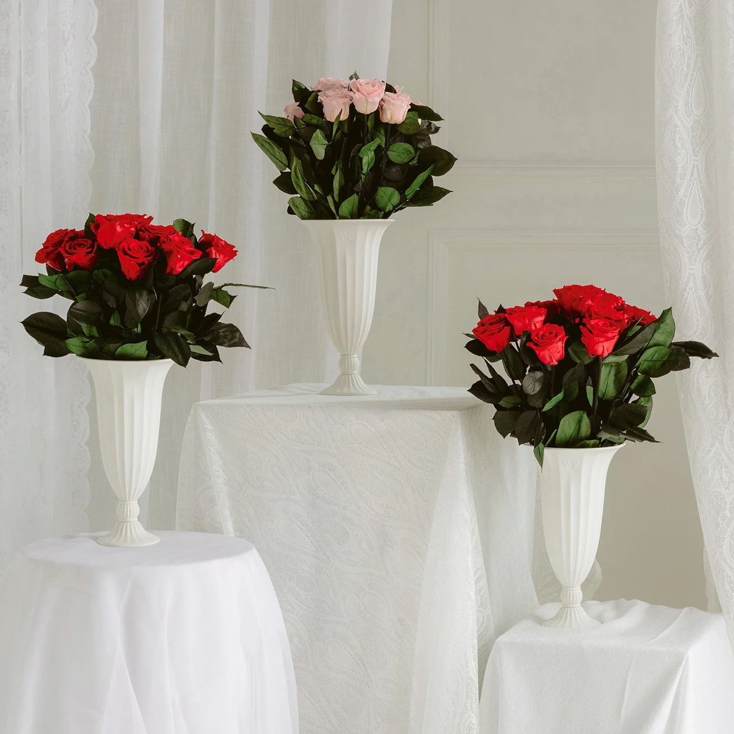 three vases of roses in red and pink