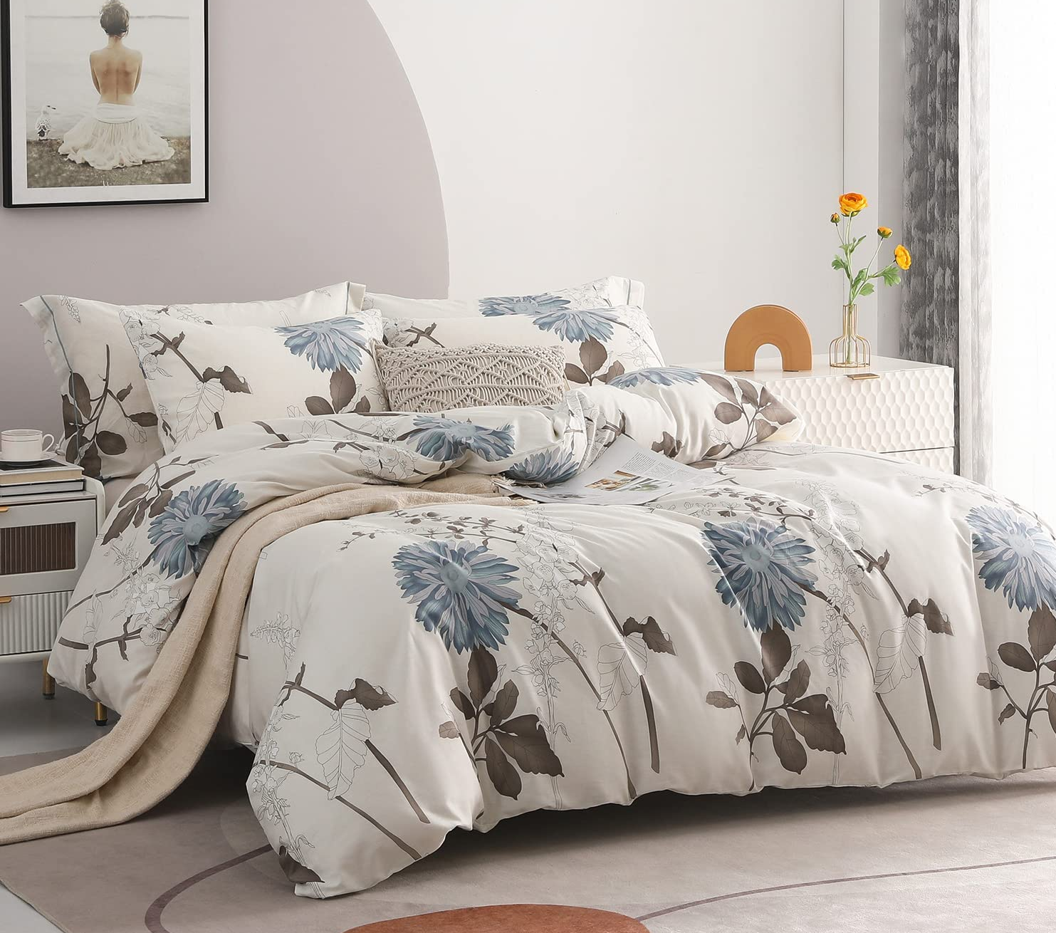 a bed made with a white, blue, and brown botanical print comforter set