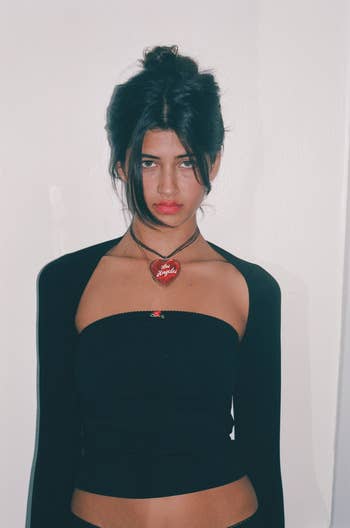 Model wearing the black tube top with a black bolero