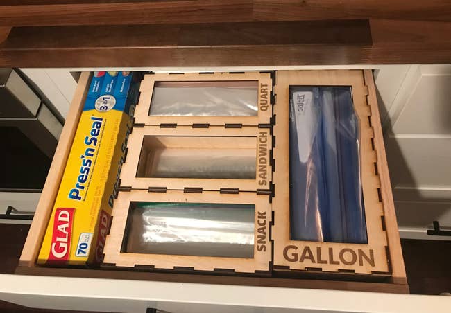 The inside of a drawer perfectly filled with these baggie organizers, there are four of them labeled 