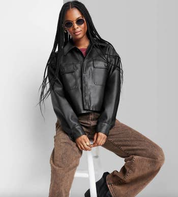 model wearing black faux leather cropped shacket