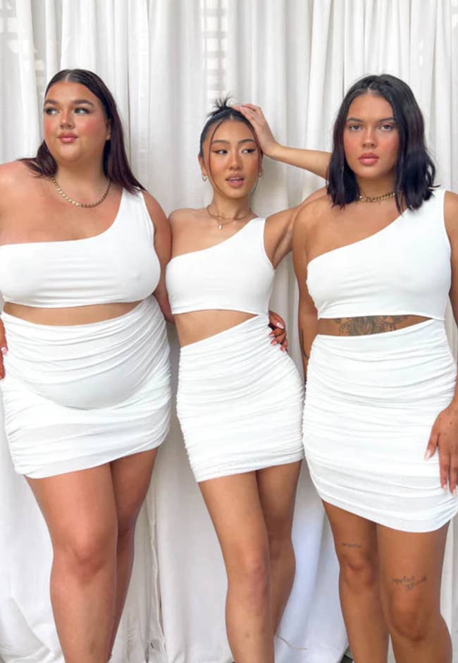 Three models wearing the dress in various sizes 