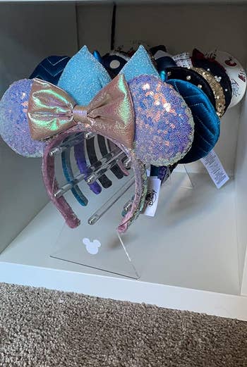 Assorted Disney themed headbands displayed on an acrylic holder