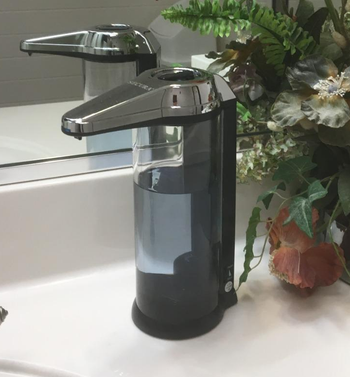 Reviewer image of soap dispenser on counter with blue soap