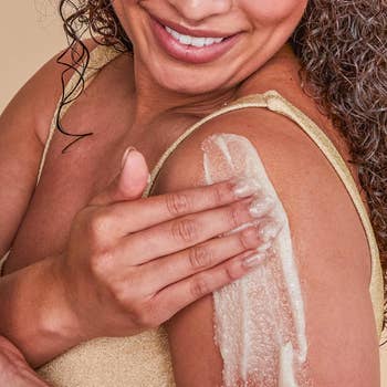 A model applying the Tree Hut sugar scrub to their skin