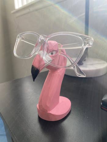 Wooden flamingo glasses holder with transparent glasses connected  its beak 