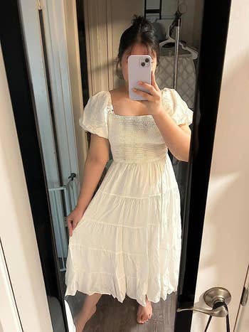 reviewer taking mirror pic wearing white dress