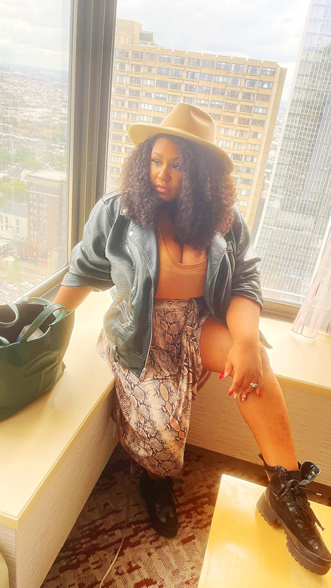 a reviewer wearing the croc-print jacket 