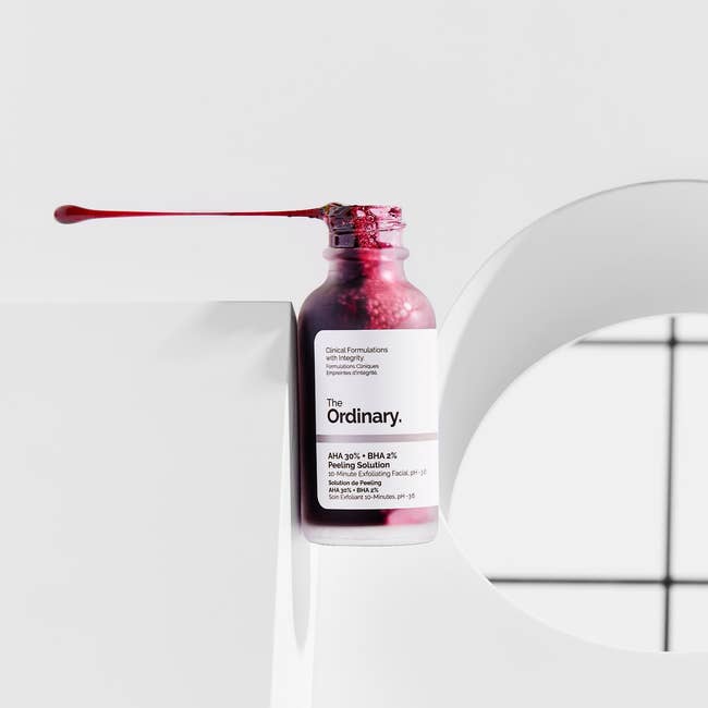 bottle of The Ordinary solution with red liquid inside