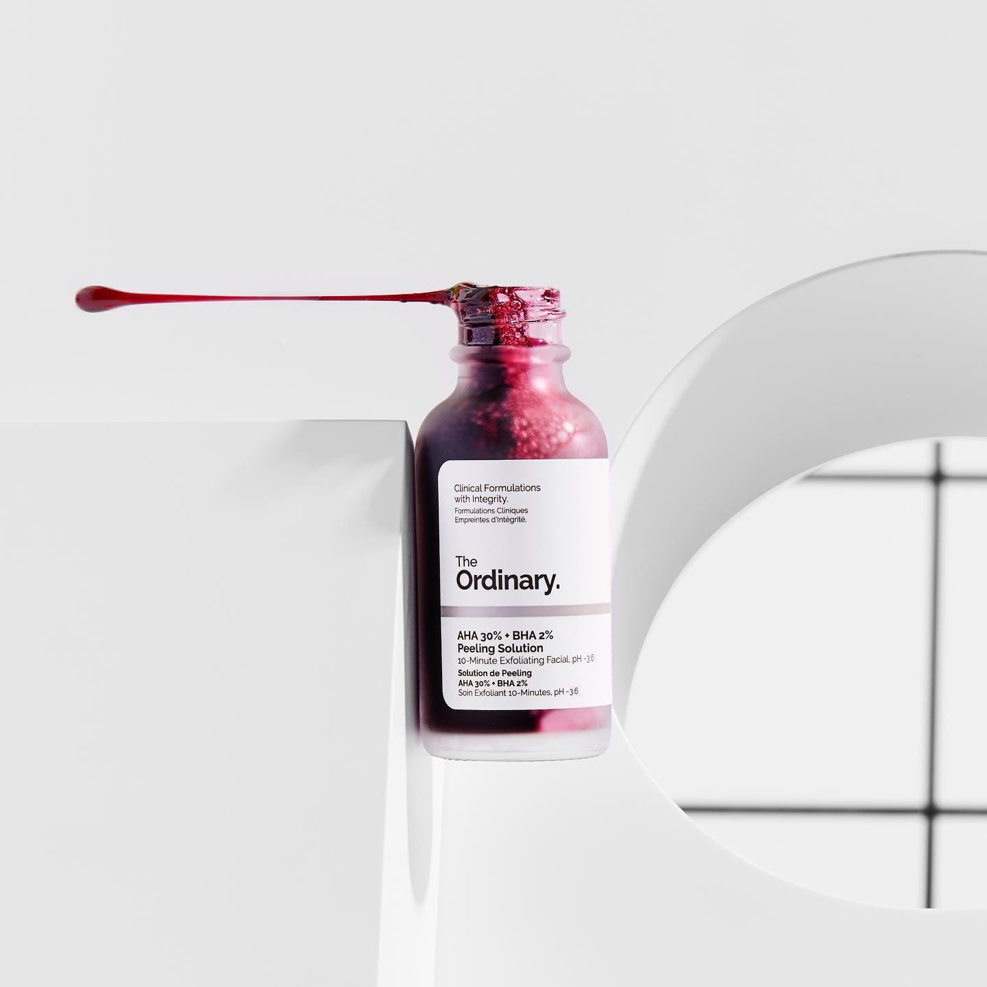 bottle of The Ordinary solution with red liquid inside