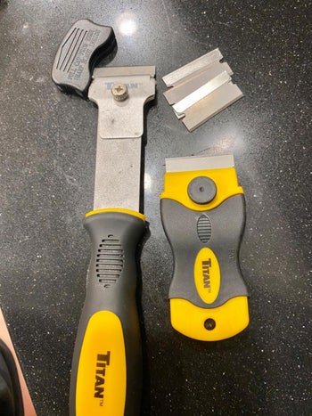Reviewer image of large and small razor scraper on black table