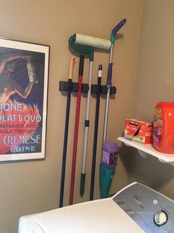 reviewer's broom holder in a laundry room