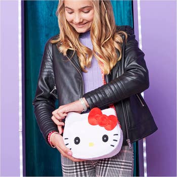 Child model wearing Hello Kitty purse