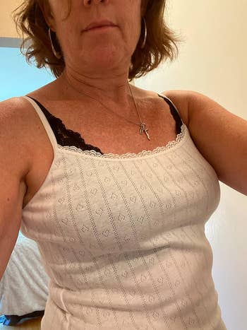 reviewer in a white lace-trimmed cami