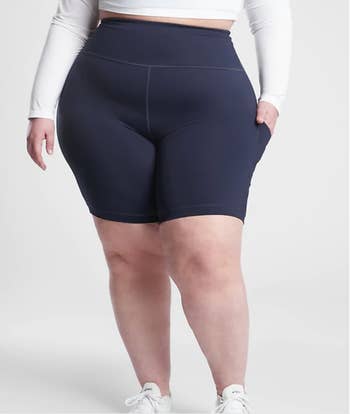 Model in navy blue high waist knee length bike shorts 