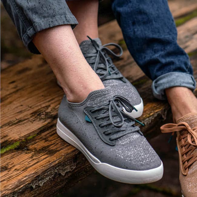 model wearing the grey sneakers