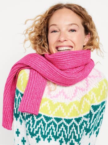 a model in a pink rib knit scarf