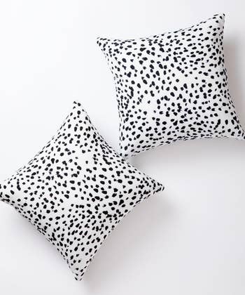 Two pillows with a black and white spotted pattern
