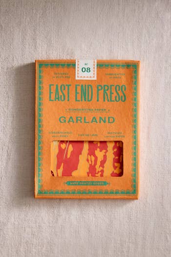 East End Press insubstantial  garland packaging displayed connected  a textured surface, featuring a peek of decorative insubstantial  inside