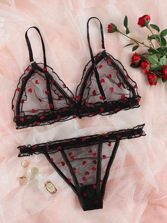 a sheer black panty and bra with red hearts on it