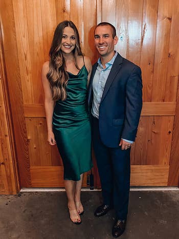 reviewer wearing the emerald green cowl neck midi dress