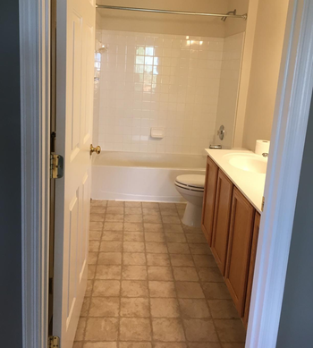 a reviewer photo of a bathroom with tan tile floors 