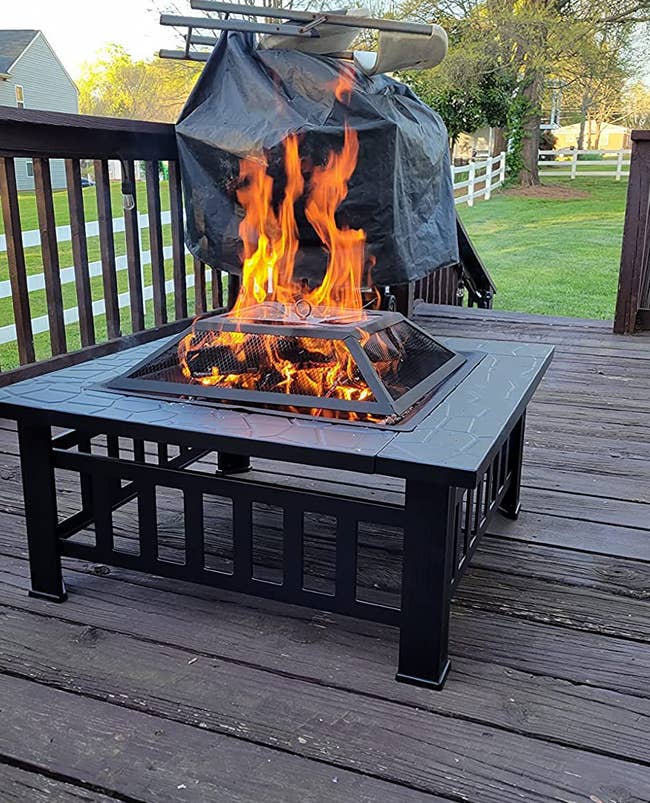 a reviewer photo of the fire pit on a back porch 